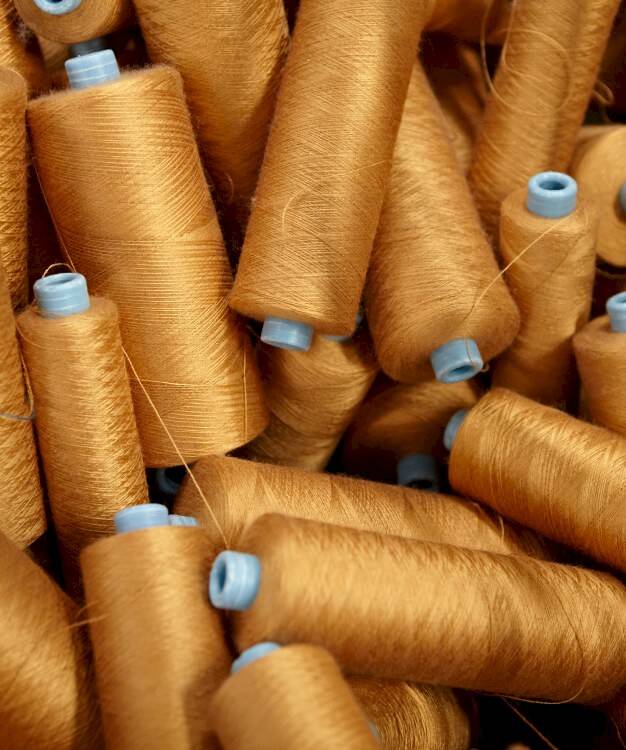 heap of golden sewing threads